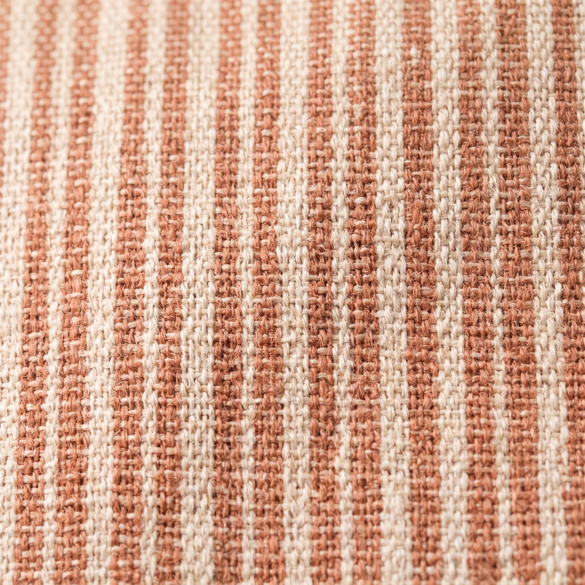 Close macro of a clay and ecru yarn-dyed stripe, woven not printed