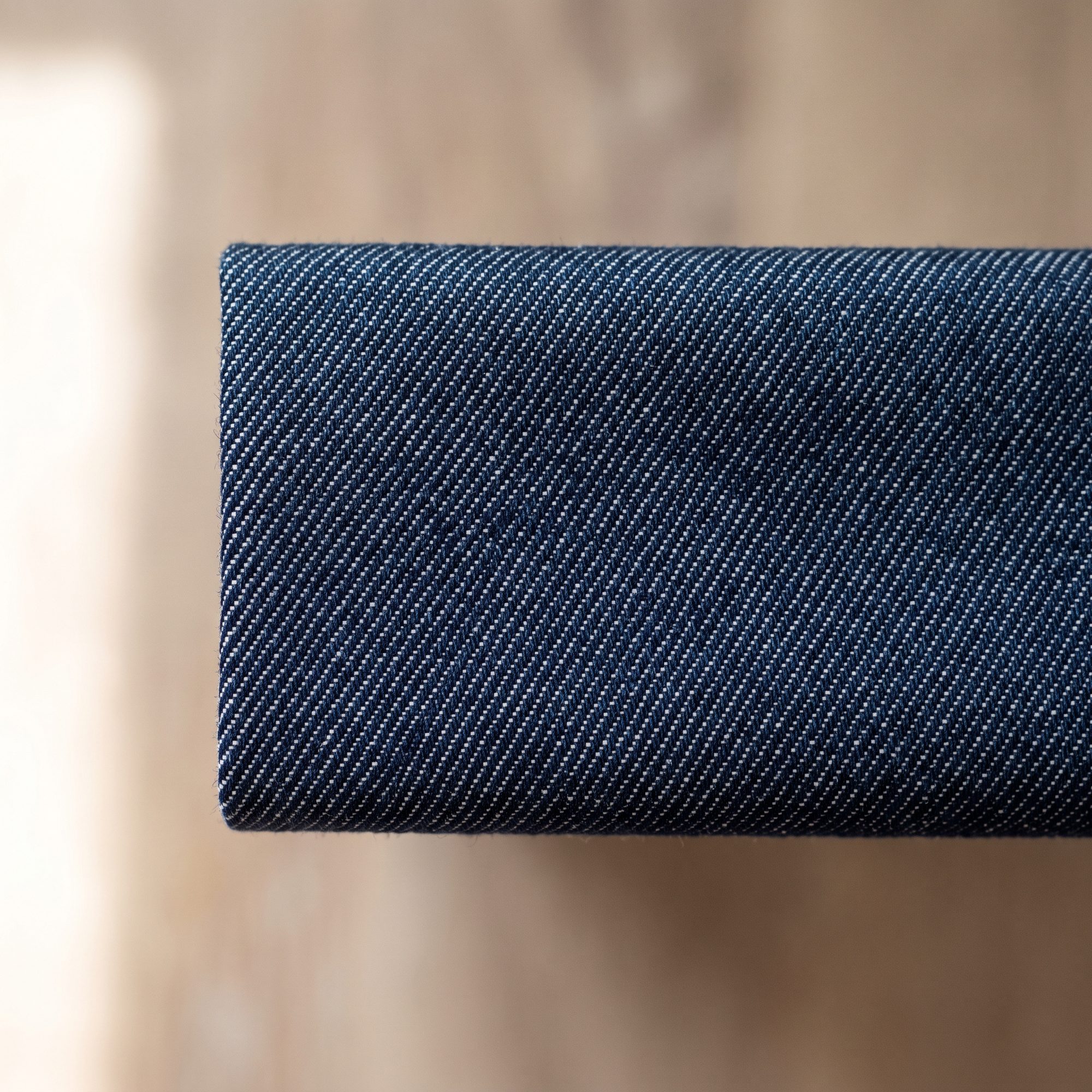 Folded length of indigo denim twill showing the diagonal warp face